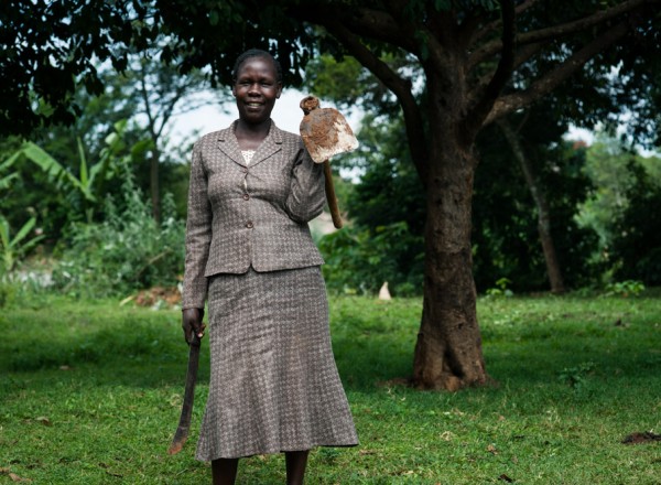 Anne holds the two tools she uses most often when farming: a machete, known in Kenya as a panga, and a short hoe called a jembe. Photo: Hailey Tucker